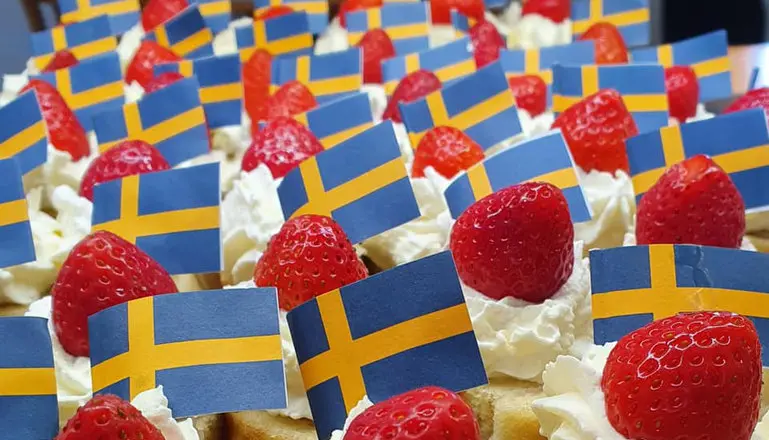 sverige flaggor på en tårta med jordgubbar